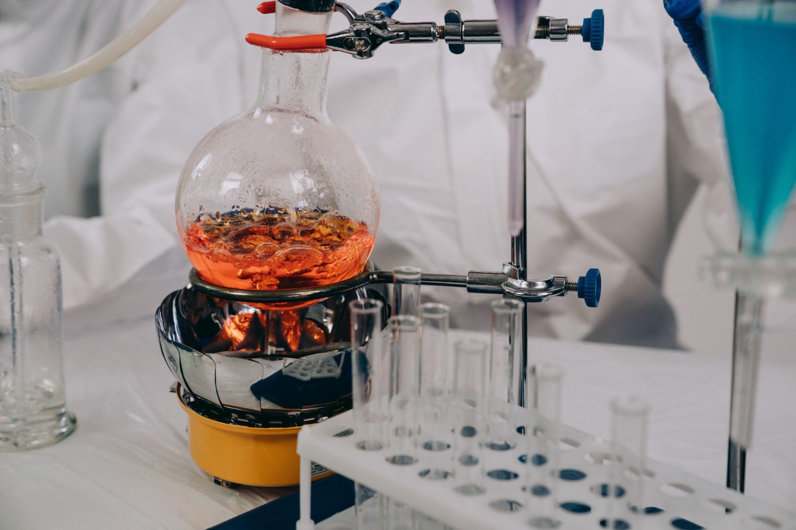 Clear glass laboratory vials on a sterile reflective surface in a cleanroom for scientists looking to Buy Laboratory Peptides UK.